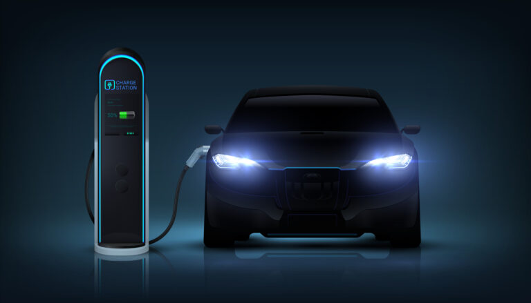 electric car with headlights glowing and plugged into a charging station
