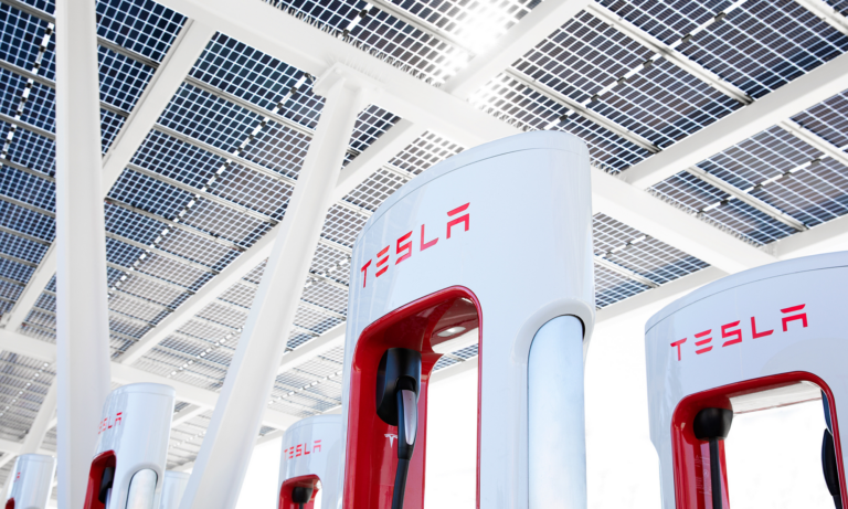 group of tesla super chargers with logo in view 1