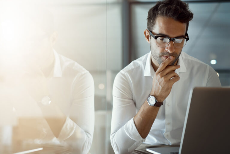 an investor researching stocks on a computer