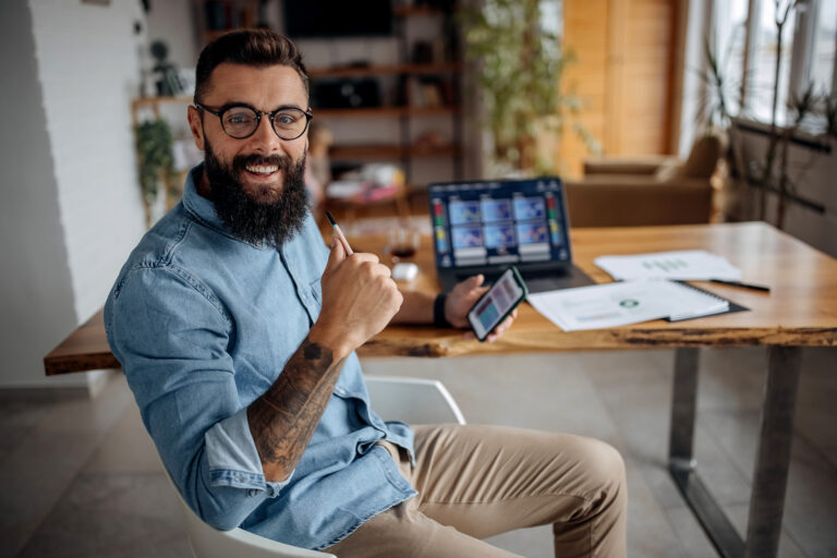 happy stock investor holding smartphone