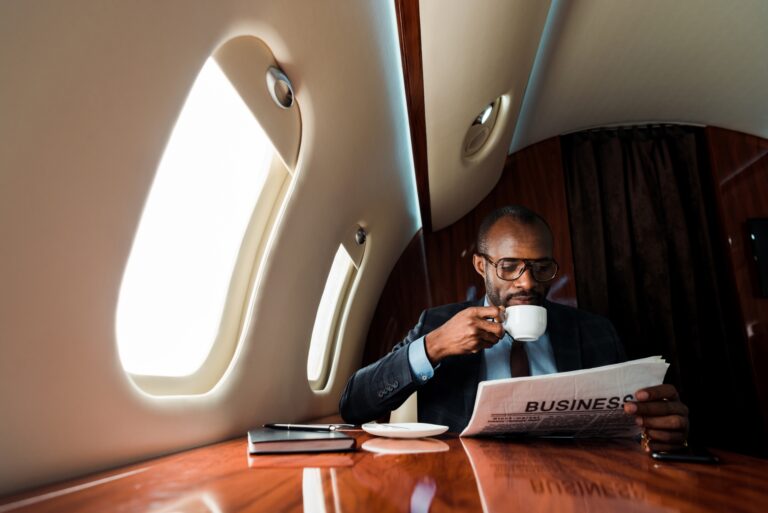 person reading a newspaper on a private jet