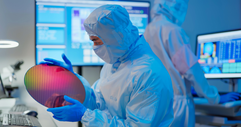 technician looking at silicon wafer gettyimages 1363604154 1201x633 30e6268