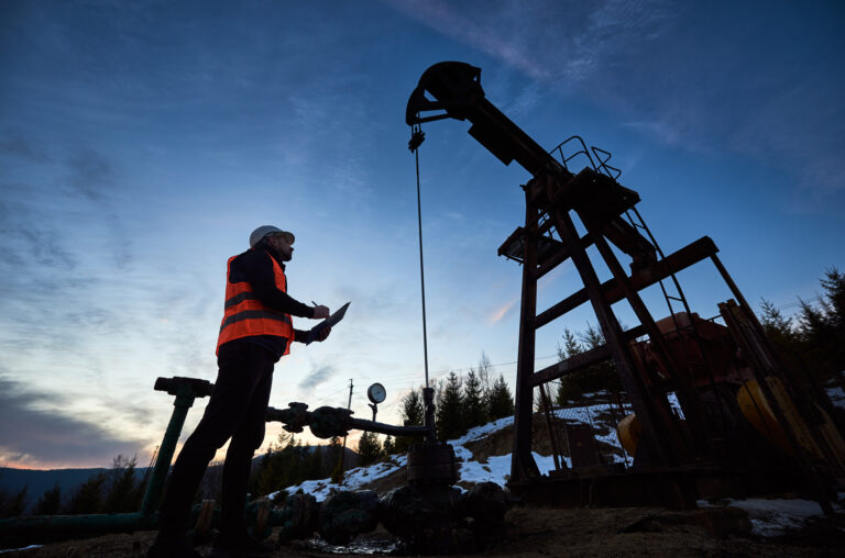 a person looking up at an oil pump