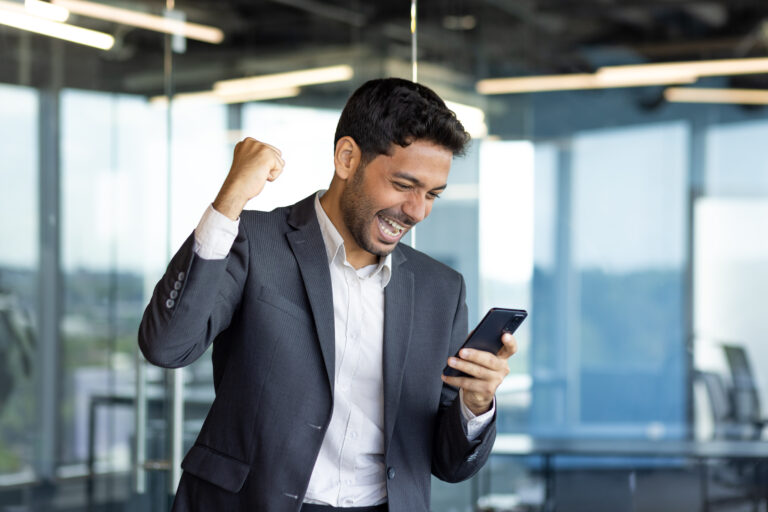 cheering good news on a smartphone