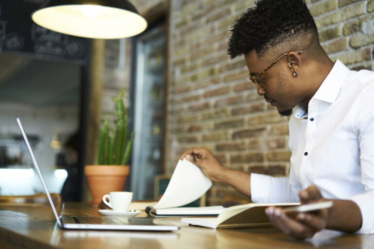 investor considers papers at a cafe