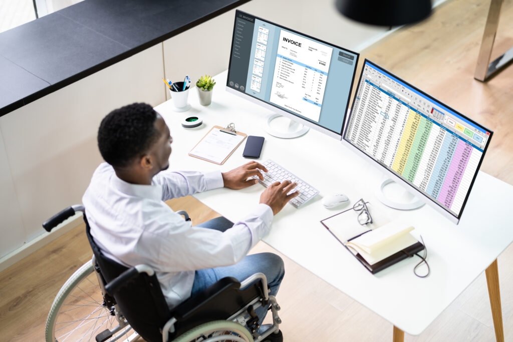 man sitting in front of two monitors