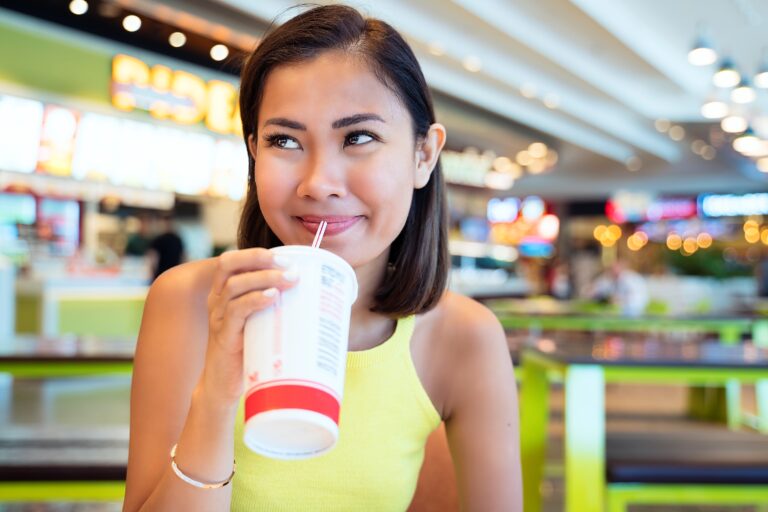 person drinking at a food court