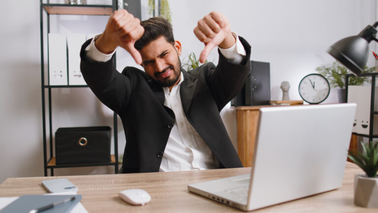 person giving a thumbs down to a computer screen