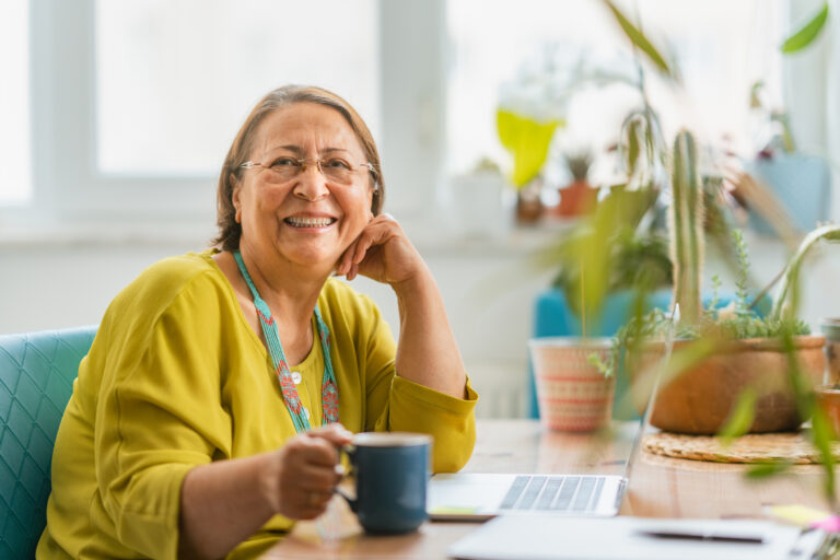 person sitting at a desk and smiling