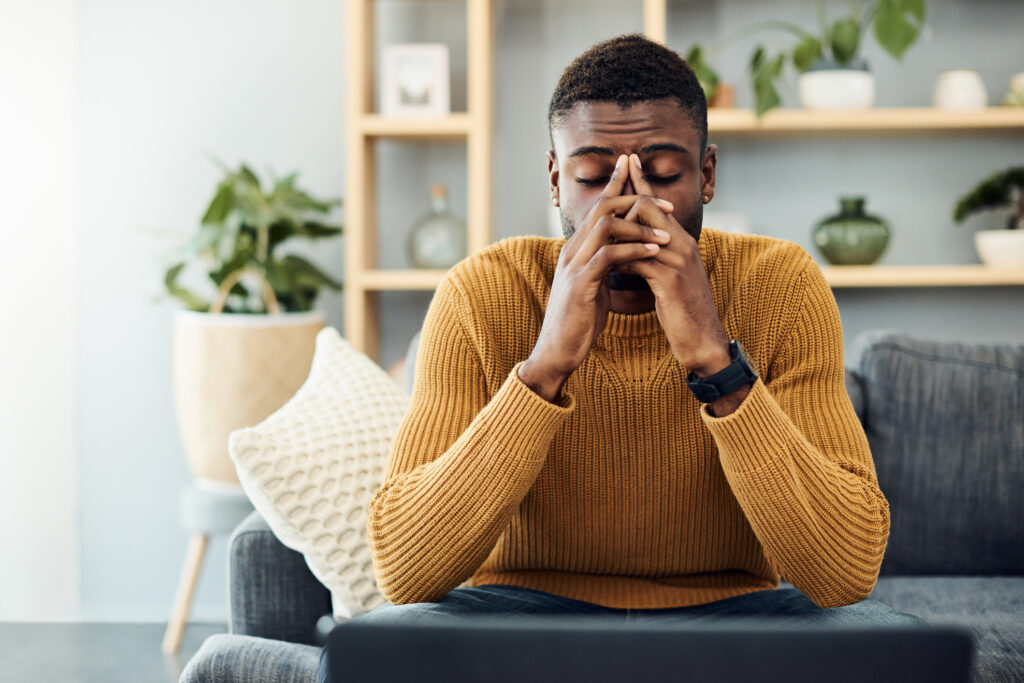 person sitting on a couch feeling worried