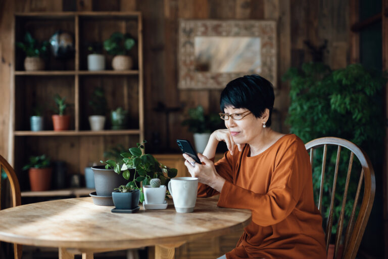 retired woman looking at phone